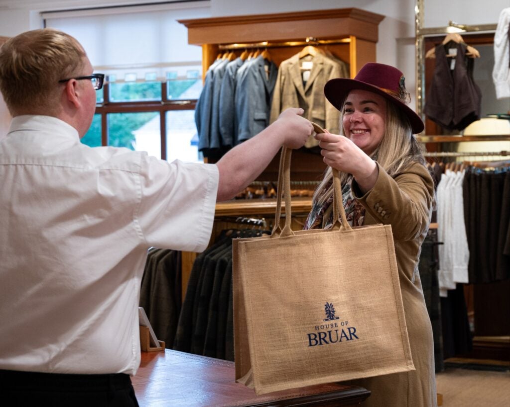 House of Bruar staff handing a shopping bag to a customer