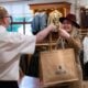 House of Bruar staff handing a shopping bag to a customer